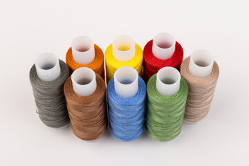 Color sewing threads isolated on white background. Different colors.Bright bobbin thread.