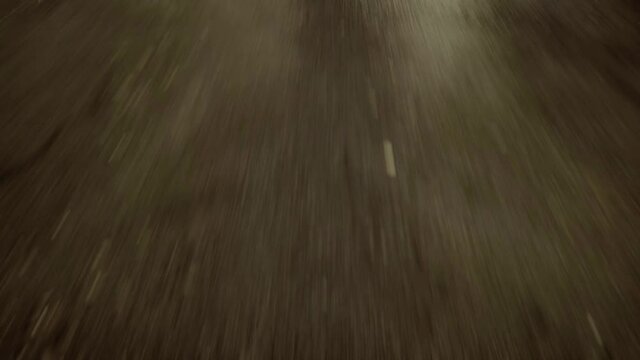 close-up cinematic POV shot of an wet asphalt road. Car is driving on the highway 
