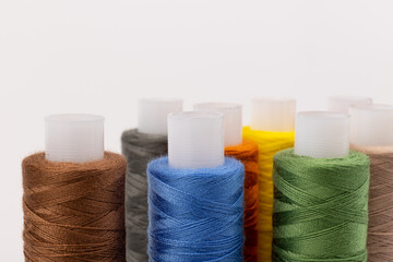 Color sewing threads isolated on white background. Different colors.Bright bobbin thread.