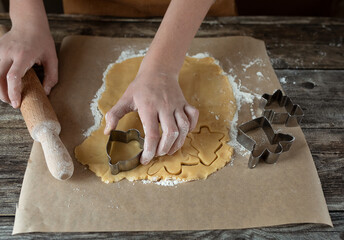 close up of hands kneading dough with flour