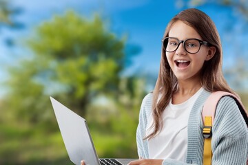 Smart young girl teenager student using digital laptop, surfing Internet,