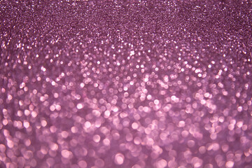 Abstract shiny blurred purple background with bokeh lights. Selective focus. Holiday.