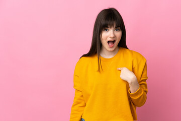 Young Ukrainian woman isolated on pink background with surprise facial expression