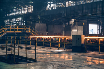 Hot steel pipe on the conveyor in Iron and Steel Factory or Pipe Mill