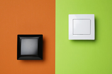 White light switches on color background, flat lay