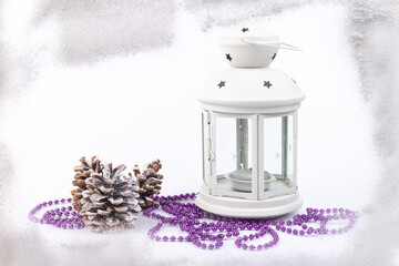 White lantern with candle inside and Christmas decoration on white background. Copy space.