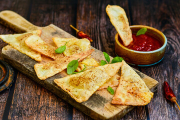  Home made ketogenic  Crispy nachos  tortilla chips with spicy red sauce. Mexican snack  for cinema.