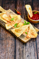  Home made ketogenic  Crispy nachos  tortilla chips with spicy red sauce. Mexican snack  for cinema.