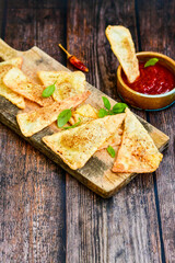  Home made ketogenic  Crispy nachos  tortilla chips with spicy red sauce. Mexican snack  for cinema.