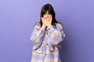 Young Ukrainian woman isolated on purple background covering mouth with hands