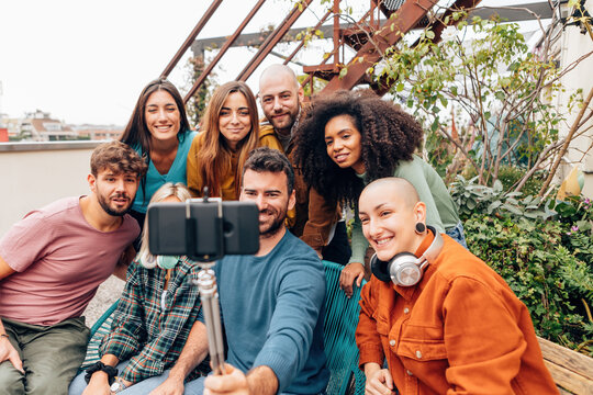 group of young making a group selfie - end of holiday or end of course photos - generation z lifestyle
