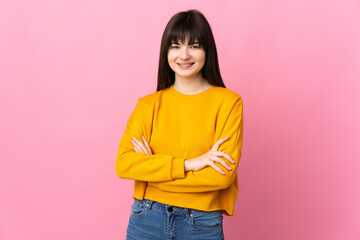 Young Ukrainian woman isolated on pink background keeping the arms crossed in frontal position