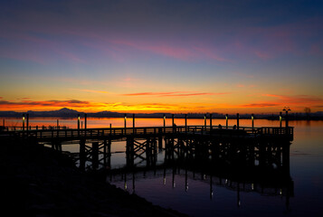 Fototapeta na wymiar Fraser River Winter Twilight. Sunrise behind a fishing pier on the Fraser River. British Columbia, Canada.