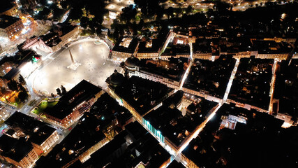 Aerial drone night shot from iconic illuminated Piazza del Popolo or People's square, an elliptical popular landmark square centered by Rome's oldest obelisk , Rome histroric centre, Italy