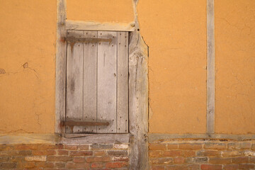 Fototapeta na wymiar A close-up of a wooden shutter in a barn 