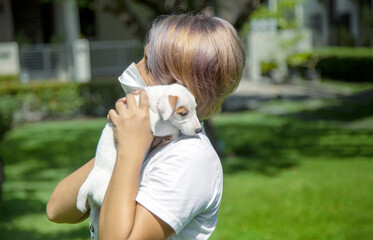 Woman wearing protective mask hug with a dog at park