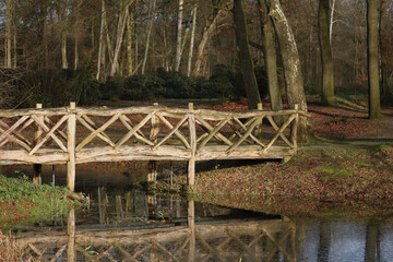 A local park with a wooden bridge over water
