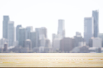 Blank wooden tabletop with beautiful blurry skyline in sunny weather on background, mockup