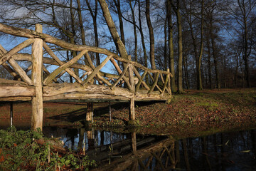 A local park with a wooden bridge over water
