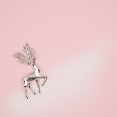 Santa reindeer on snow and pastel pink bacground. Winter holiday concept. New Year background.