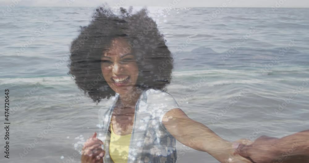 Poster Animation of happy african american couple walking at beach over sea