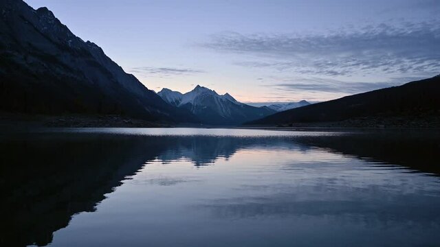 Scenery of Medicine Lake with Canadian Rockies and sky reflection in the morning at Jasper national park