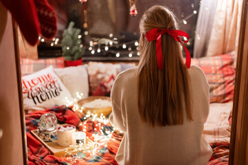 faceless woman with long blondie hair and red bow hair clip enjoyment relaxing at home in cozy...