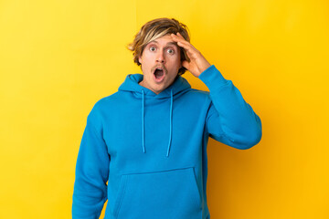 Handsome blonde man isolated on yellow background has realized something and intending the solution