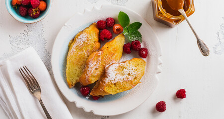 French sweet toasts with berries. Old gray vintage background. Top view. Copy space.