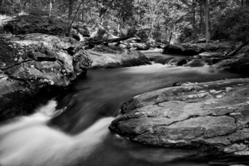 Black and White photograph of cliffs along Deer Creek in Harford County Maryland with rushing water and springtime water flow