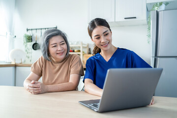 Asian nurse at nursing home take care of disabled senior elderly woman