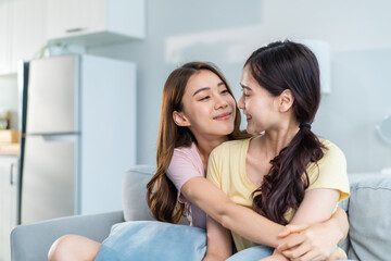 Obraz na płótnie Canvas Asian beautiful lesbian women couple hugging girlfriend in living room