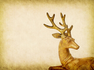 Christmas golden deer on old paper, holiday decorations in home interior