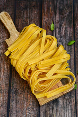 Raw fresh  uncooked tagliatelle egg pasta . Ready for cooking. Italian food concept. Kitchen poster