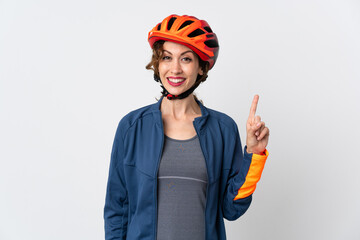 Young cyclist woman isolated on white background showing and lifting a finger in sign of the best