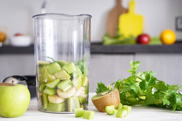 Hand blender for mixing organic raw fresh fruits for making vitamin diet smoothie, healthy food.
