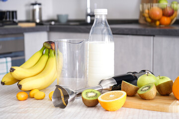 Home kitchen with ripe fruit table and hand blender.