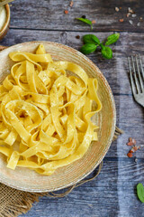 Italian food . Fresh home made  tagliatelle vegetarian  egg pasta  with ,parmesan cheese ,fresh parsley  and black pepper.Pasta cacio e pepe