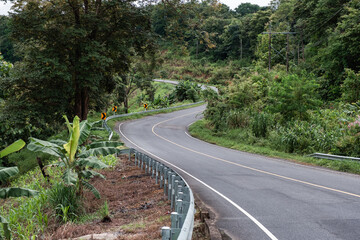 Winding road on top of mountain in tropical rainforest at Nan province