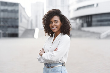 Young businesswoman in a city looking at camera, African american student girl portrait, Young...