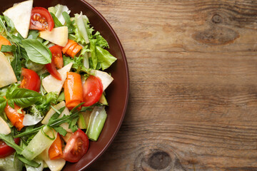 Delicious turnip salad served on wooden table, top view. Space for text