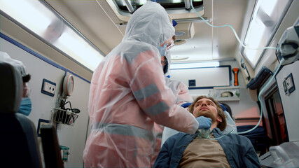 Mixed race doctors taking nasophargeal swab of patient for coronavirus sample © stockbusters