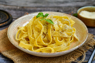  Italian home made fettuccine pasta with  parmesan cheese and black pepper. Tipical Roman dish