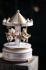 White vintage toy carousel with horses