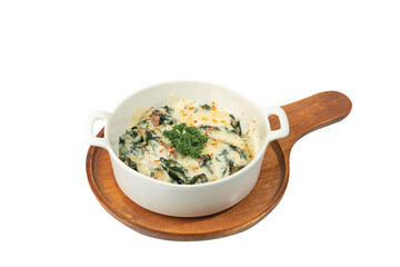 Baked Spinach with Cheese in white plate on wooden table