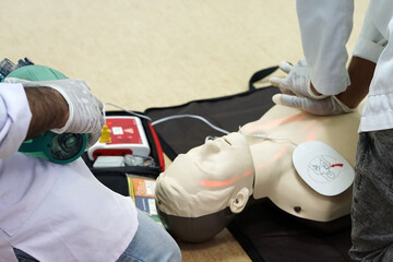 Chest compressions by a student on a simulation dummy during basic life support with an automatic...