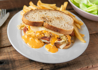 Very juicy delicious Reuben sandwich served with french fries and green salad