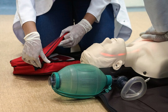 Chest compressions by a student on a simulation dummy during basic life support with an automatic external defibrillator. Simulation training scenario