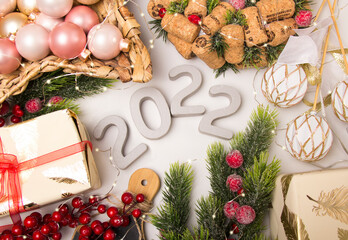 New Year decorations on a white table with the inscription 2022, top view.