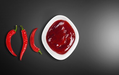 Hot chili peppers sauce. Homemade rose harissa in a bowl.